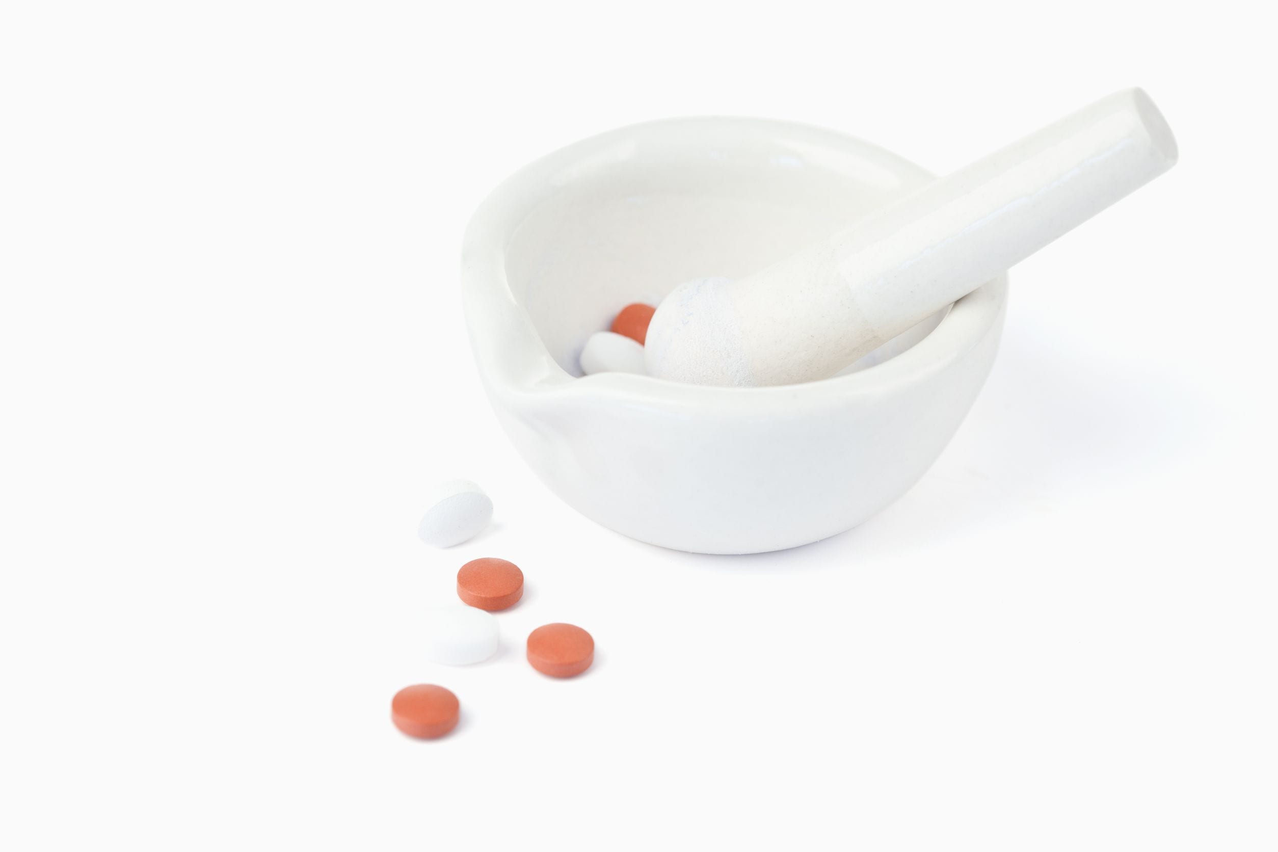 10207514 - mortar and pestle with pills against a white background